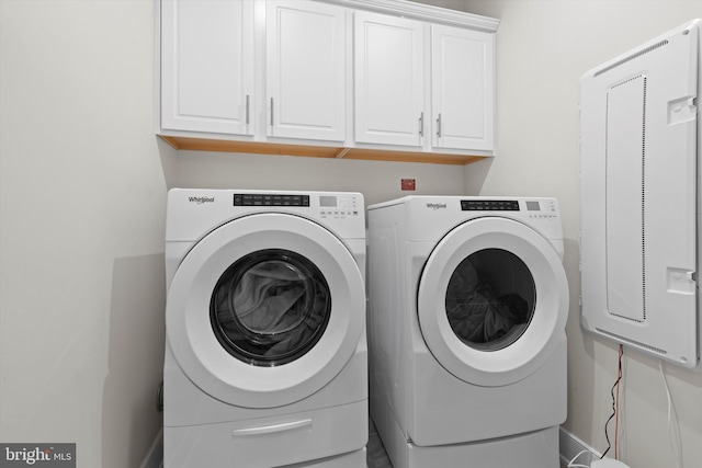 laundry area featuring cabinets and washer and dryer