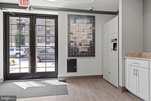 doorway featuring a wealth of natural light, light hardwood / wood-style floors, and french doors