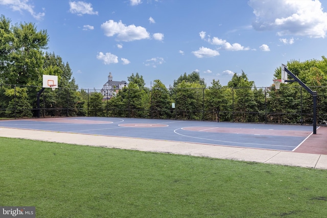 view of basketball court featuring a lawn