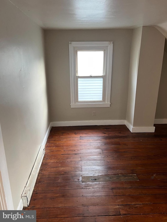 empty room with dark hardwood / wood-style flooring