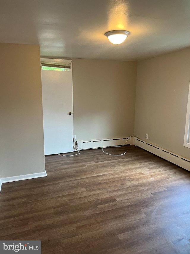 empty room with dark hardwood / wood-style floors