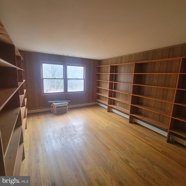 interior space featuring wooden walls and light wood-style floors