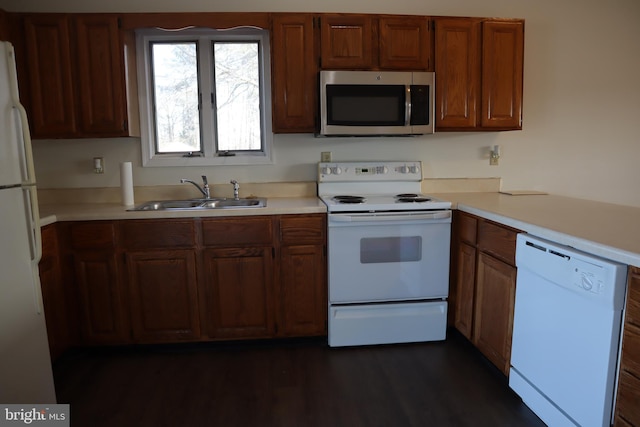 kitchen featuring dark hardwood / wood-style floors, sink, and white appliances