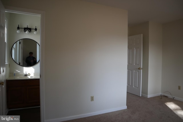 interior space with light colored carpet and sink