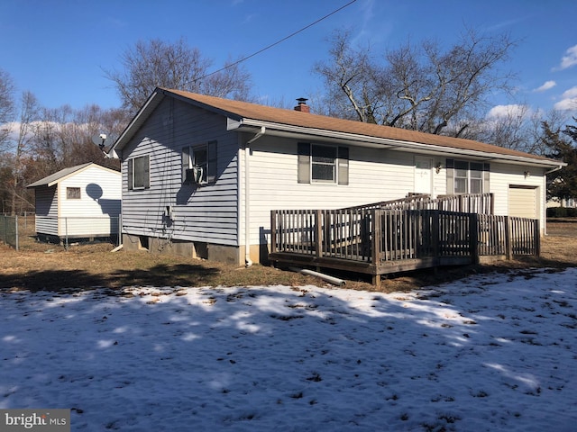 snow covered house featuring a deck