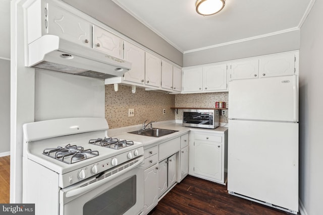 kitchen with a sink, light countertops, dark wood finished floors, white cabinets, and white appliances