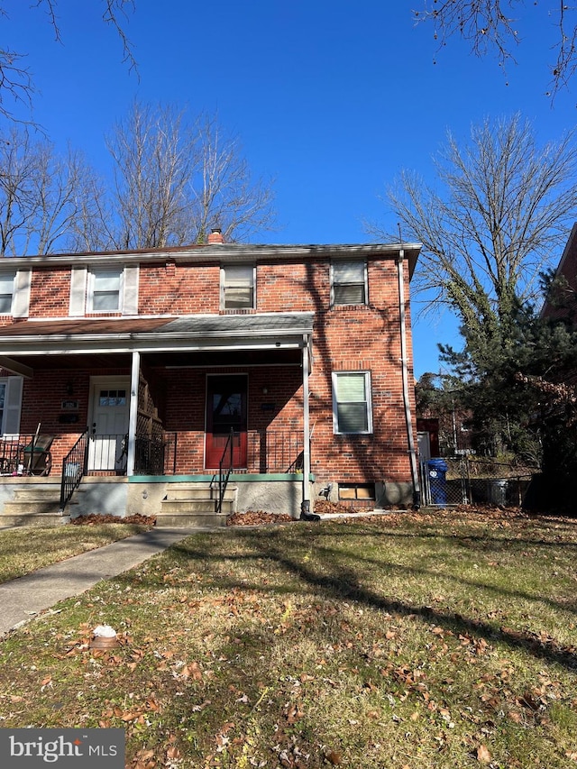 view of front facade with a porch and a front lawn