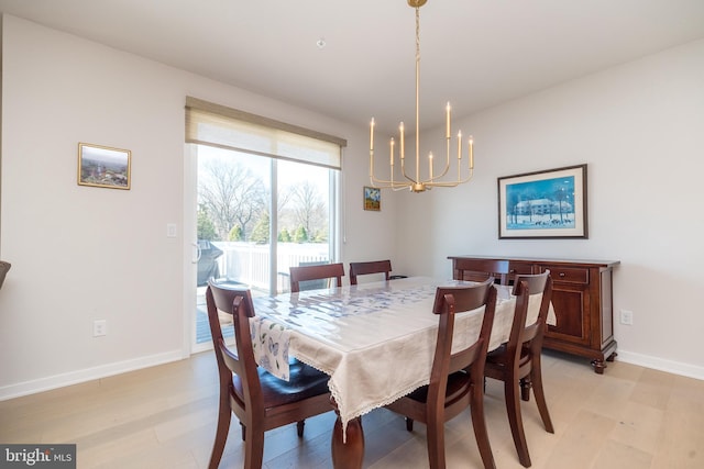 dining area featuring an inviting chandelier and light wood-type flooring