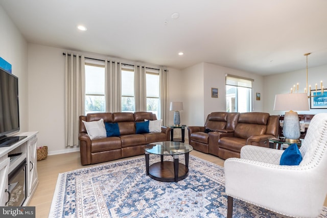 living room with a notable chandelier and light hardwood / wood-style flooring