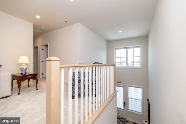 corridor with light colored carpet