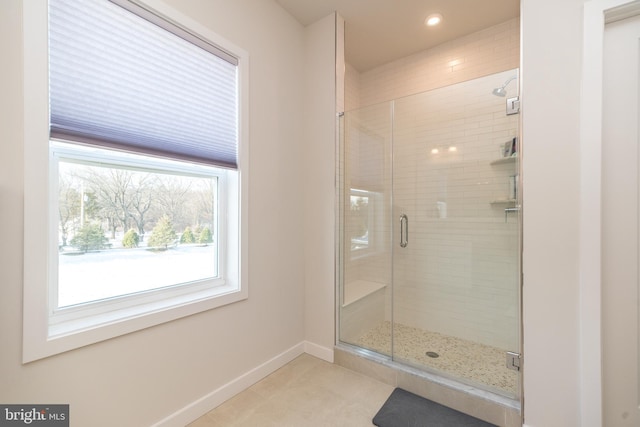 bathroom featuring a shower with door and tile patterned floors