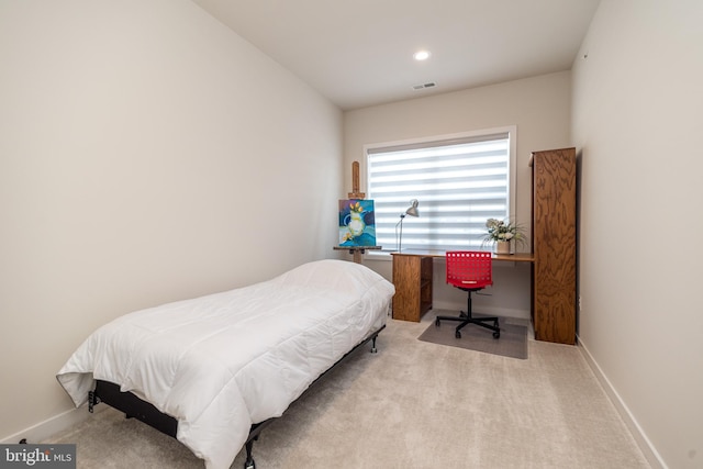 bedroom featuring light colored carpet