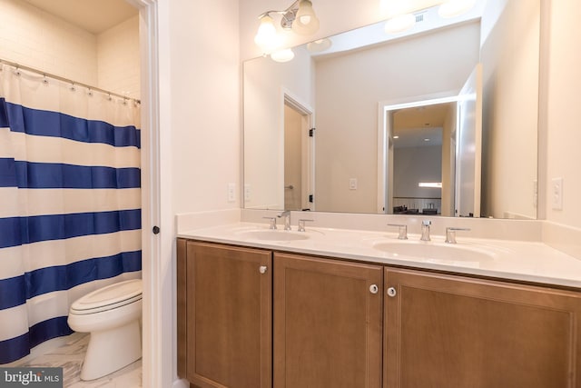 bathroom with vanity, toilet, and walk in shower