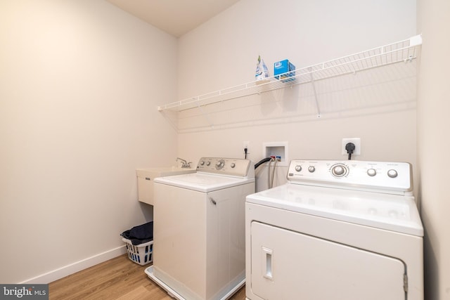 washroom featuring independent washer and dryer and light hardwood / wood-style floors