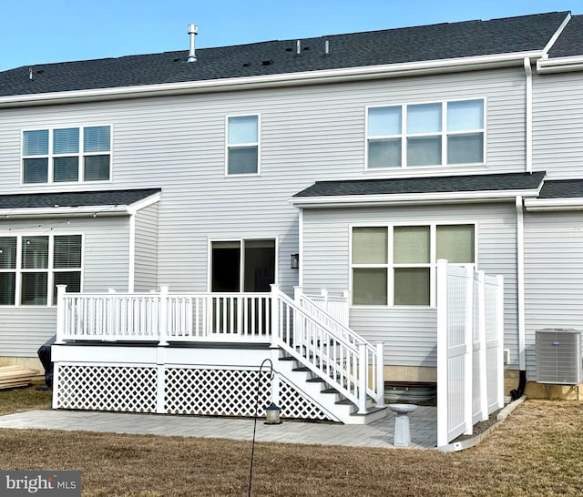 rear view of house with a wooden deck and central air condition unit