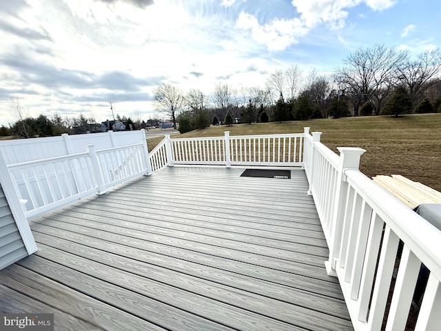 wooden deck featuring a yard