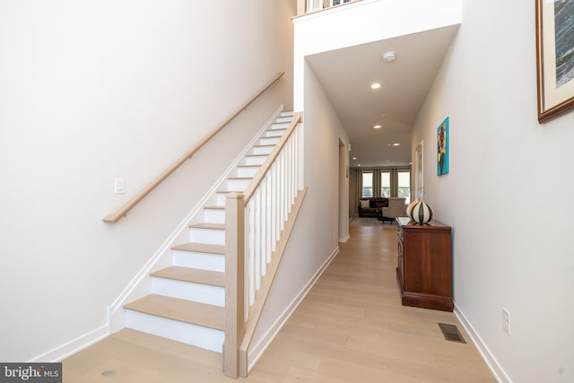 staircase with wood-type flooring