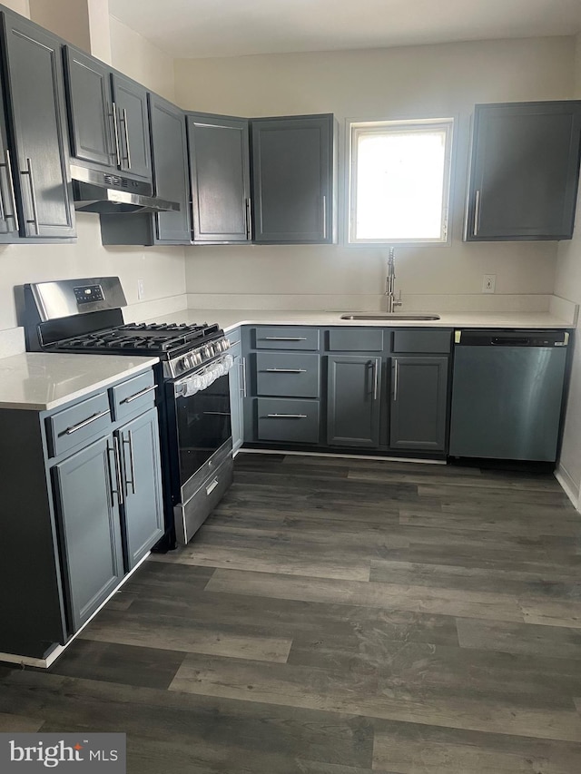 kitchen featuring dark hardwood / wood-style flooring, sink, gray cabinetry, and appliances with stainless steel finishes