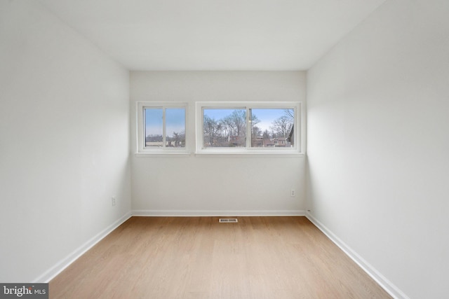 unfurnished room with light hardwood / wood-style floors