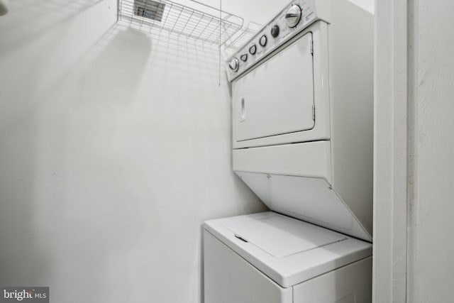 washroom featuring stacked washer / dryer