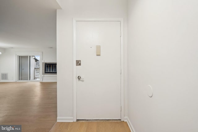 hall with hardwood / wood-style flooring