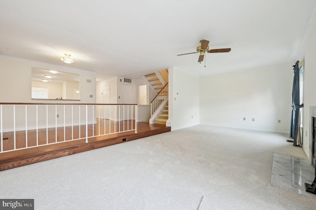 unfurnished room featuring crown molding, ceiling fan, and carpet flooring