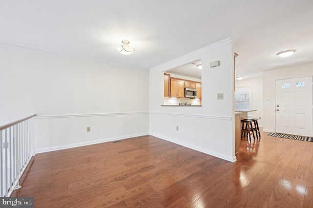 unfurnished living room with dark wood-type flooring