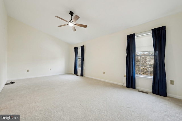 unfurnished room with ceiling fan, light colored carpet, and lofted ceiling