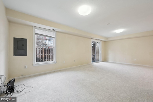 carpeted empty room with electric panel