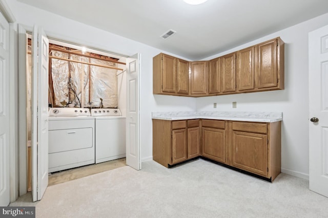 laundry room featuring light colored carpet and washing machine and clothes dryer