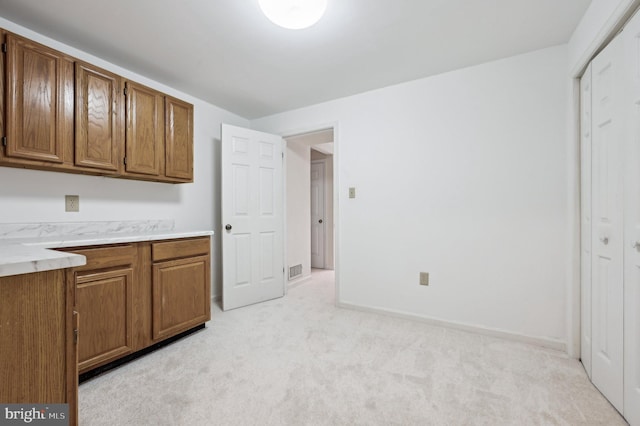 kitchen with light carpet