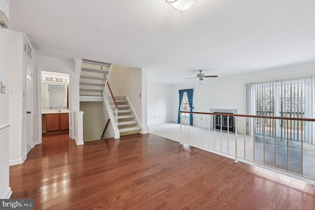 empty room with dark wood-type flooring and ceiling fan