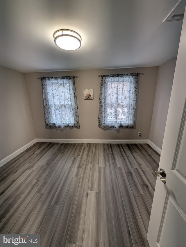 unfurnished room featuring hardwood / wood-style flooring