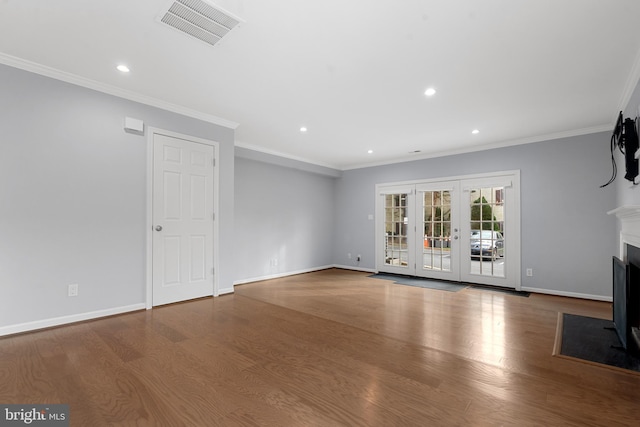 unfurnished living room featuring crown molding, hardwood / wood-style floors, and french doors