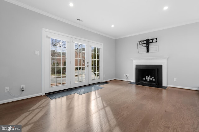 unfurnished living room featuring crown molding and hardwood / wood-style floors