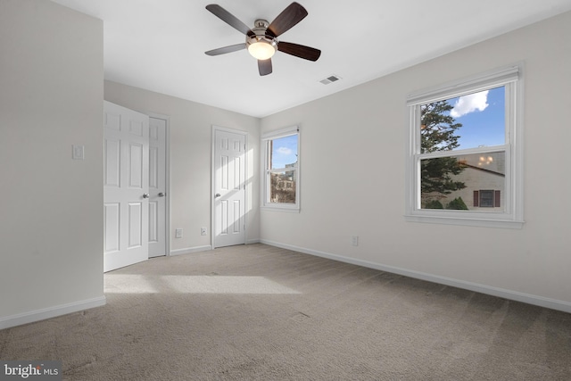 unfurnished room with light carpet and ceiling fan