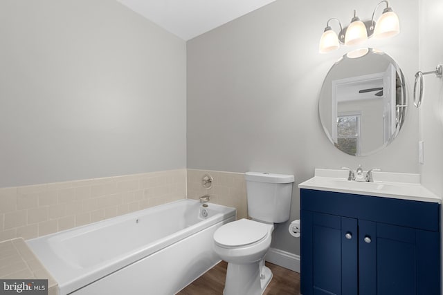 bathroom with vanity, a tub to relax in, wood-type flooring, and toilet