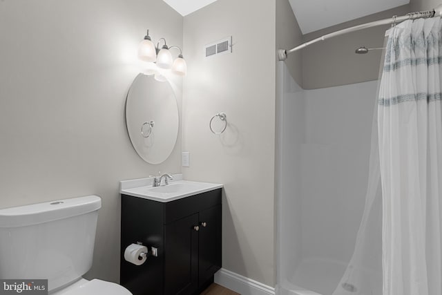 bathroom with vanity, curtained shower, and toilet