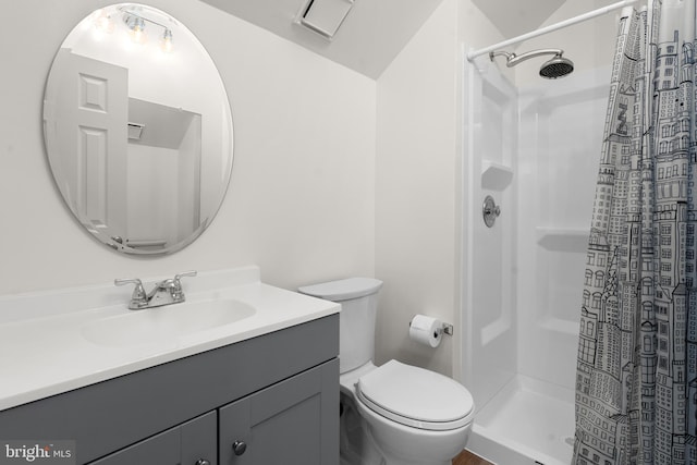 bathroom featuring vanity, toilet, and curtained shower