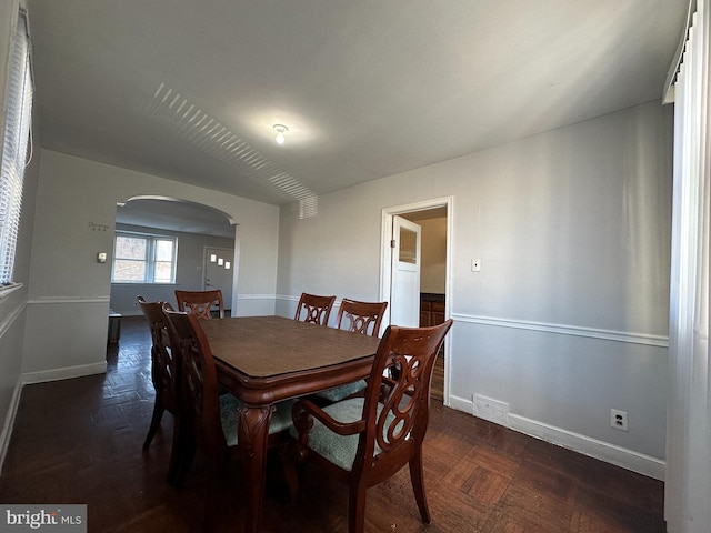 dining area with dark parquet flooring