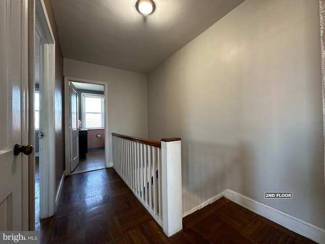 hallway featuring dark parquet flooring