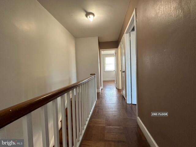 hallway with dark parquet floors