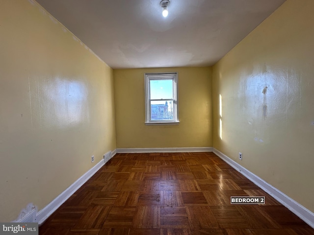 empty room featuring dark parquet flooring