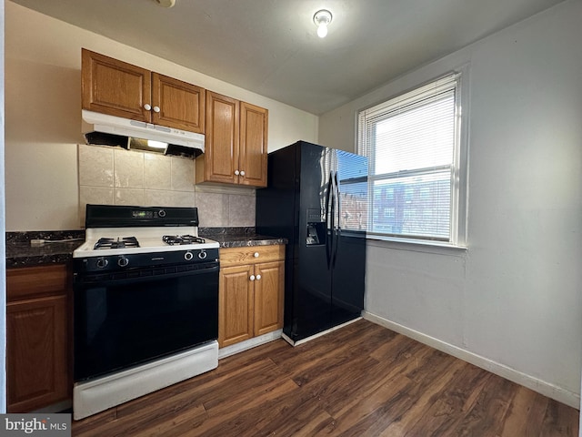 kitchen with dark hardwood / wood-style floors, decorative backsplash, and black appliances