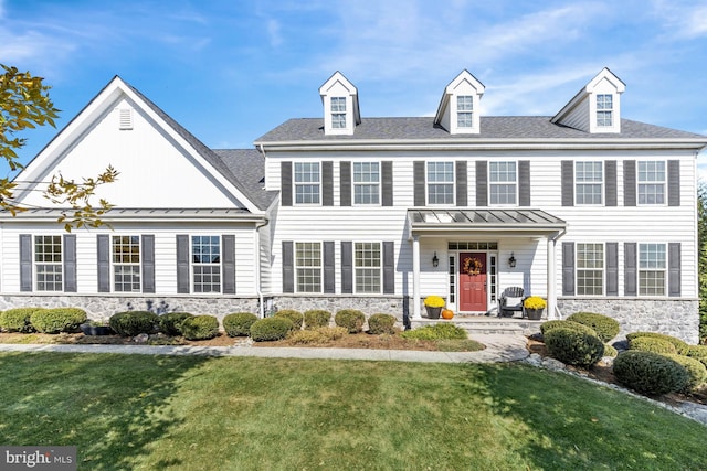 colonial inspired home with a front lawn