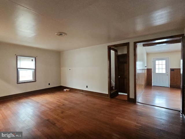 unfurnished room featuring dark hardwood / wood-style flooring