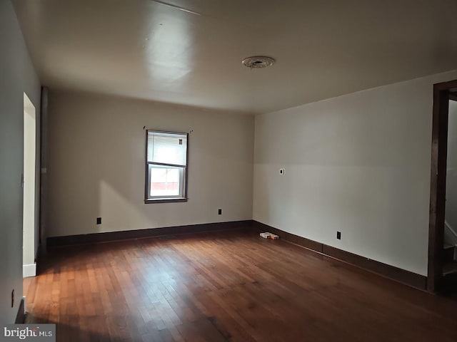 spare room featuring dark wood-type flooring