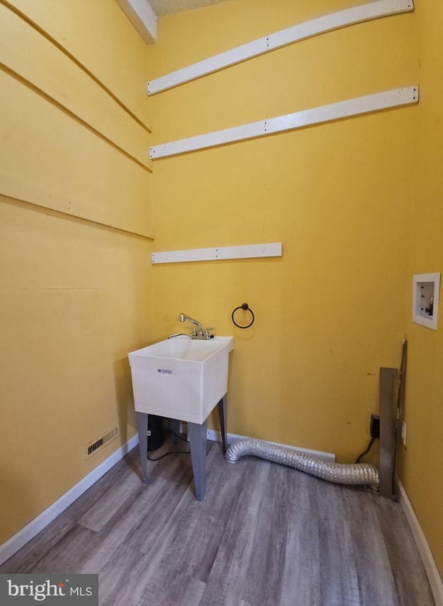 laundry area with hookup for a washing machine and hardwood / wood-style flooring