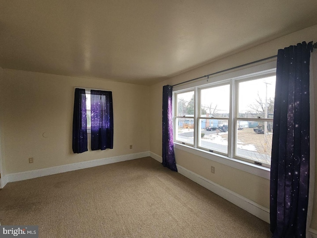 unfurnished room with carpet flooring