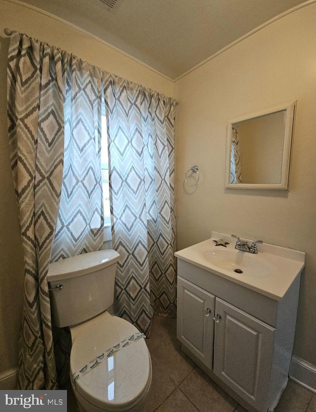 bathroom featuring ornamental molding, vanity, toilet, and tile patterned flooring